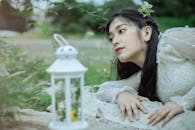 Woman Lying Near a Lantern