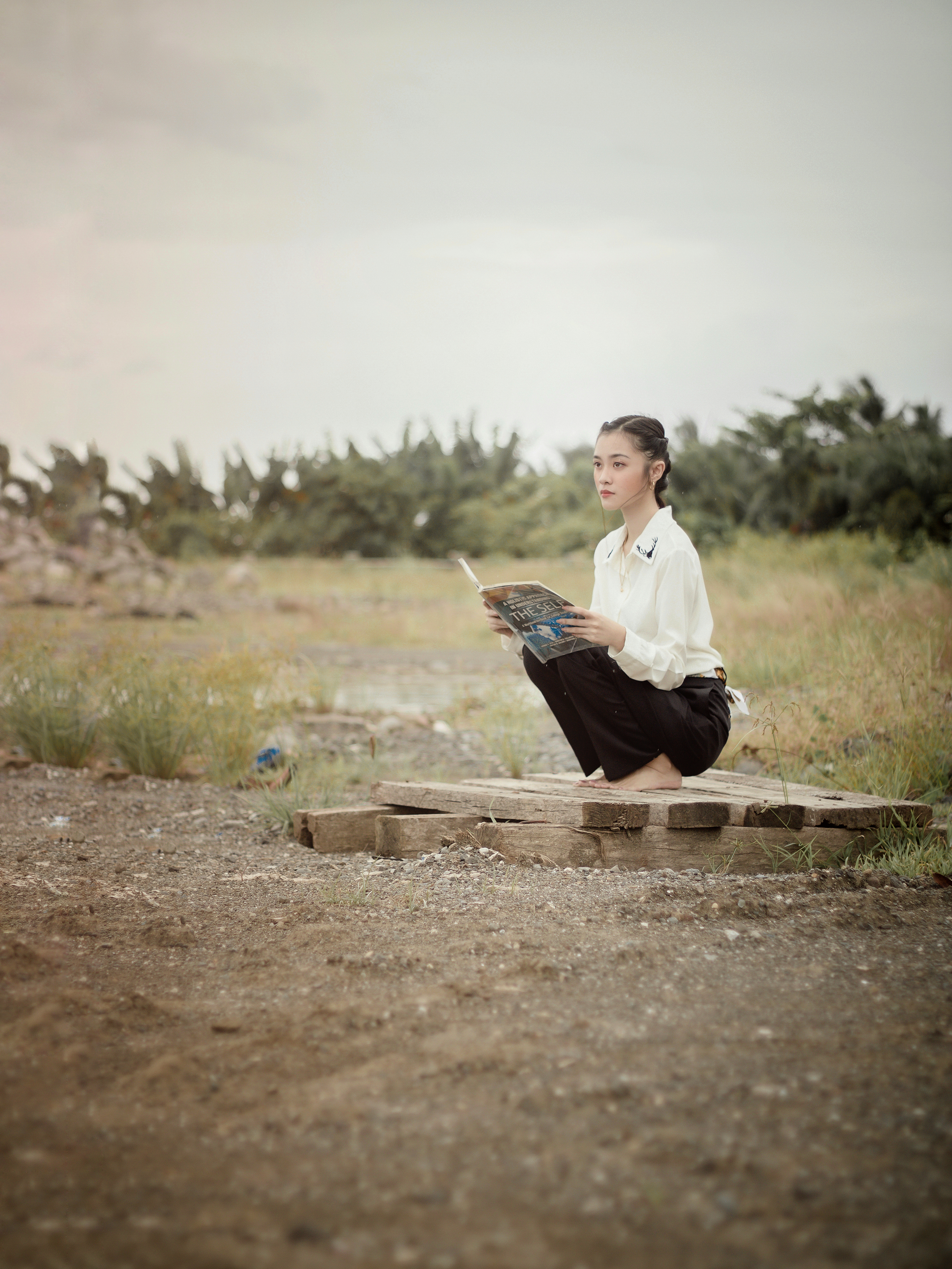 Woman in White Long Sleeves Shirt Sitting on Brown Wooden Planks · Free ...