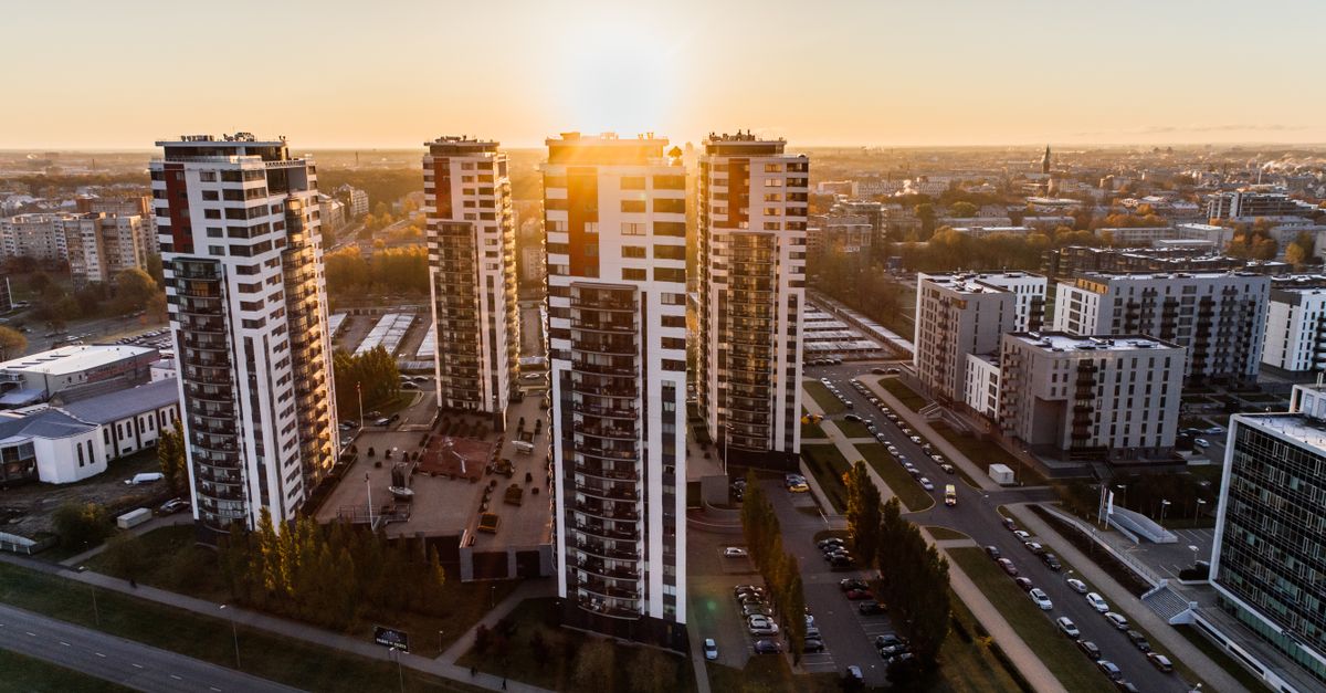 Captivating high-rise buildings silhouetted by a setting sun in a bustling cityscape.