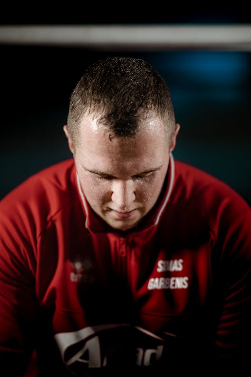 Focused strong sweaty sportsman in gym