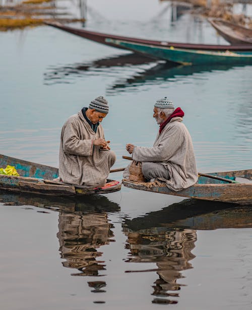 Elderly Men Sitting on Boats