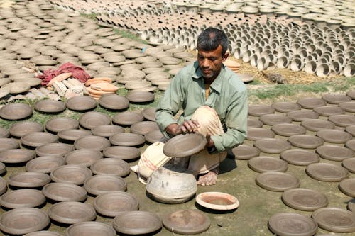 Man holding an Earthenware Dish 