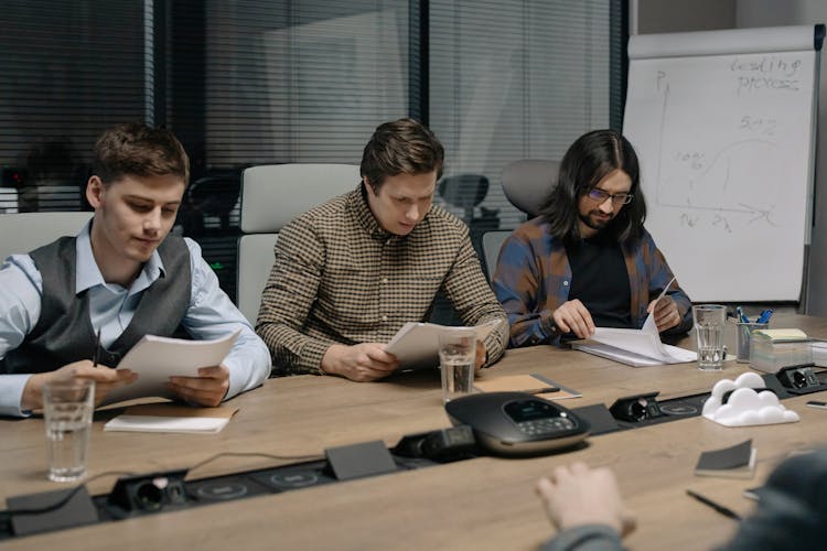 Businessmen Looking At Contract Documents