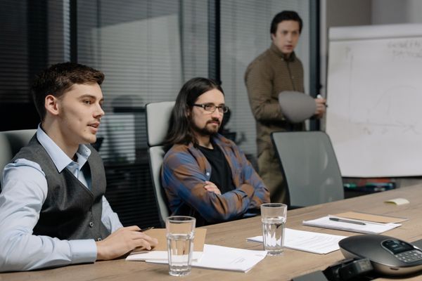 Colleagues discussing paperwork in an office meeting