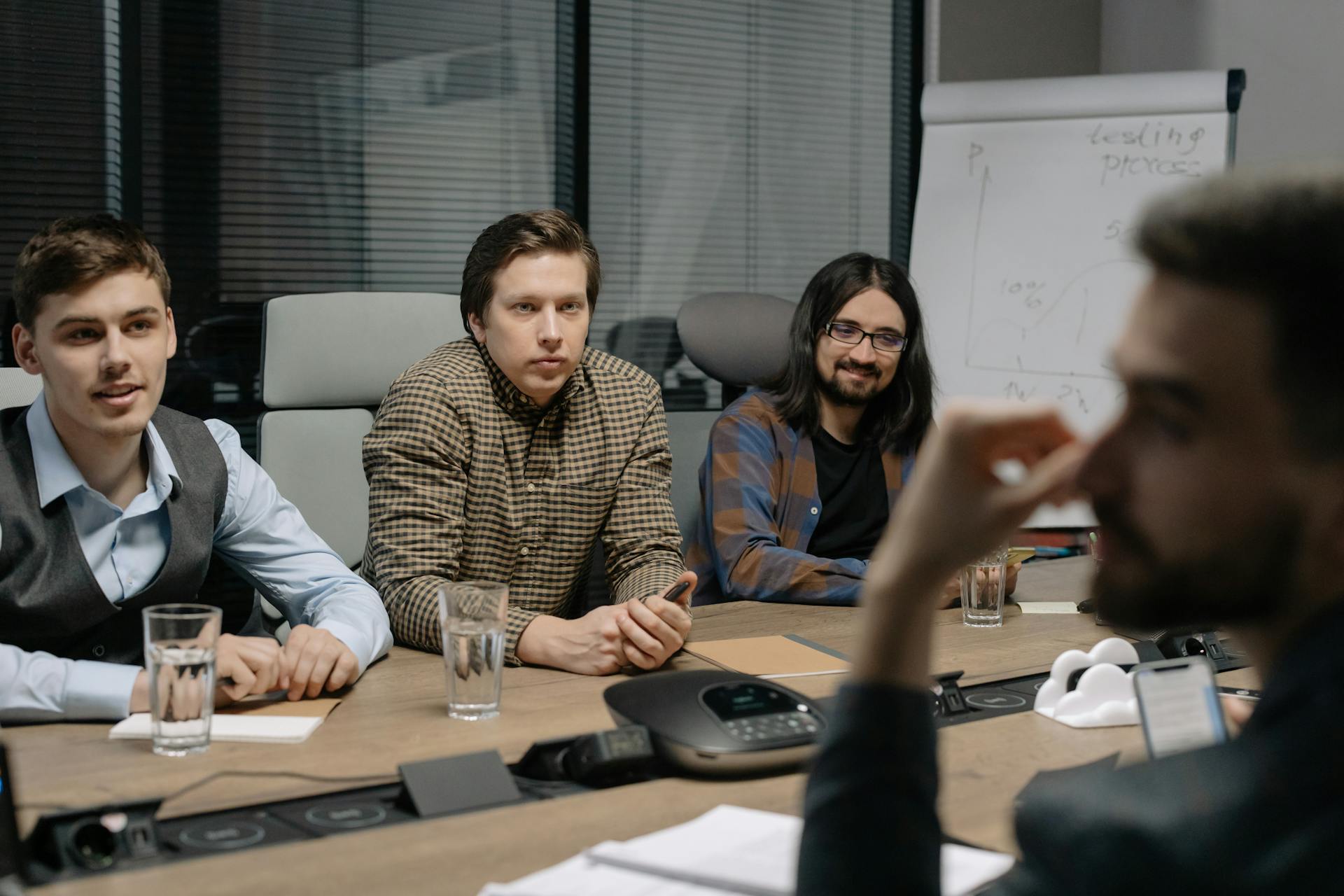 Professional team engaged in a business meeting at a conference table in a modern office environment.