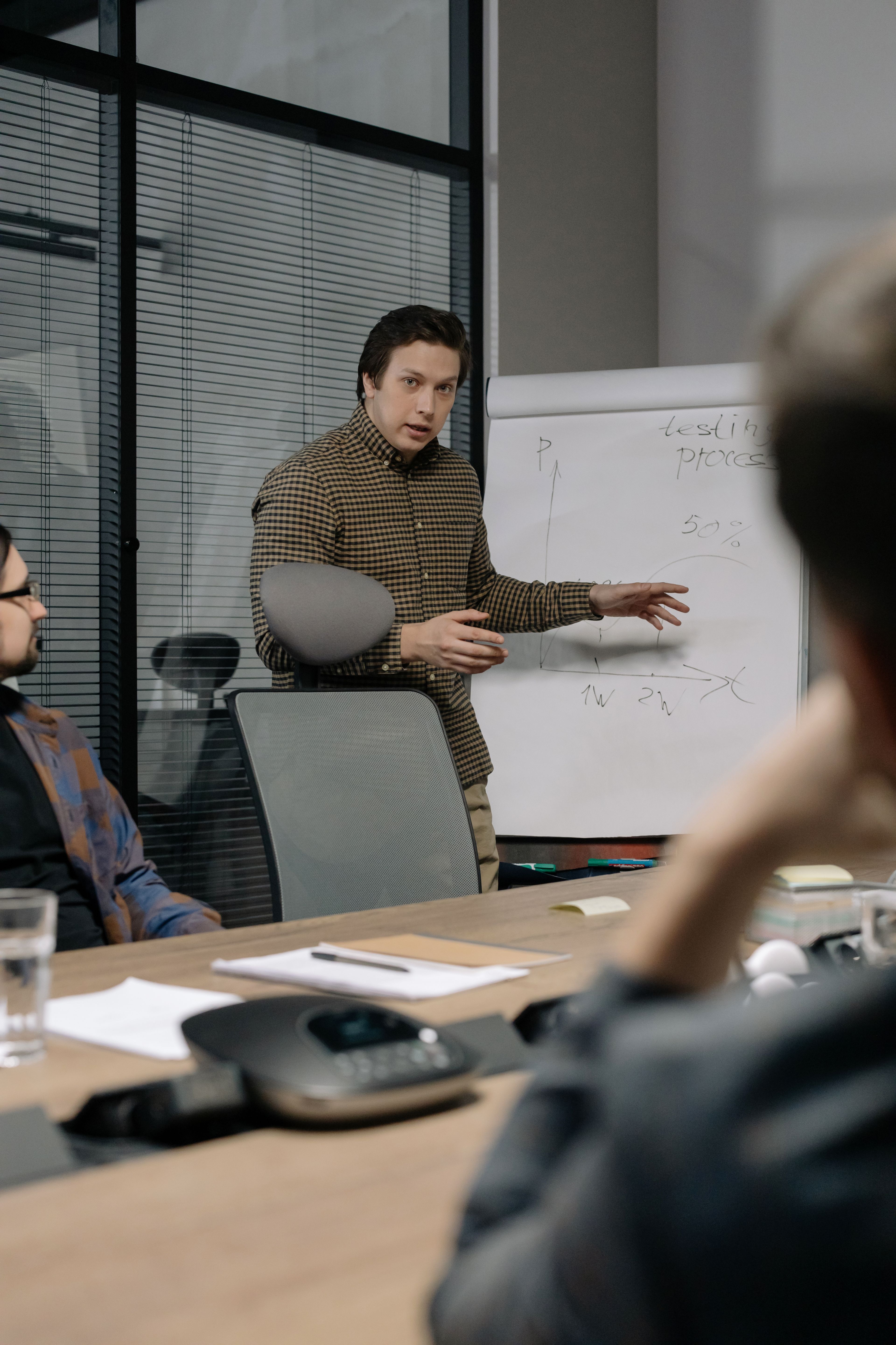 A businessman presenting to colleagues in a meeting