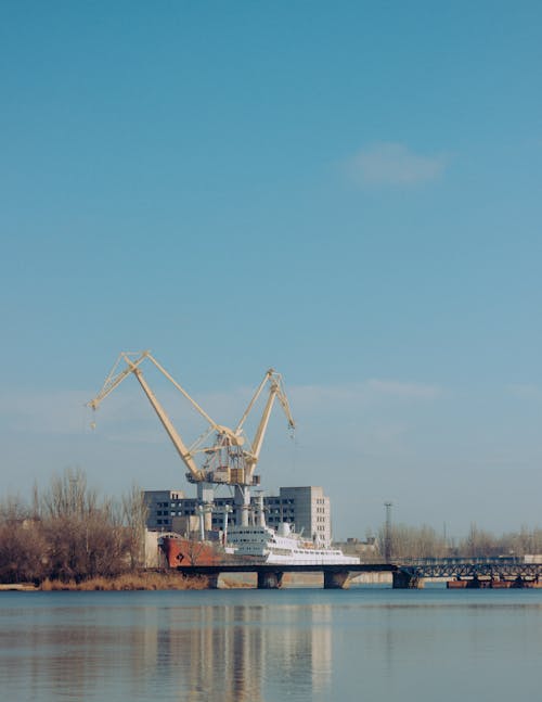 Construction crane on river bank