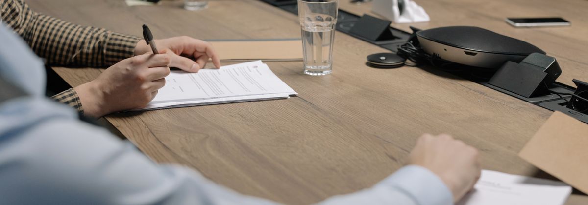 A counselor reviewing paperwork at a desk