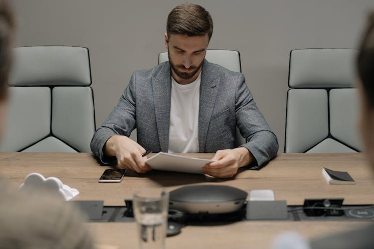 A Businessman Looking At Contract Documents