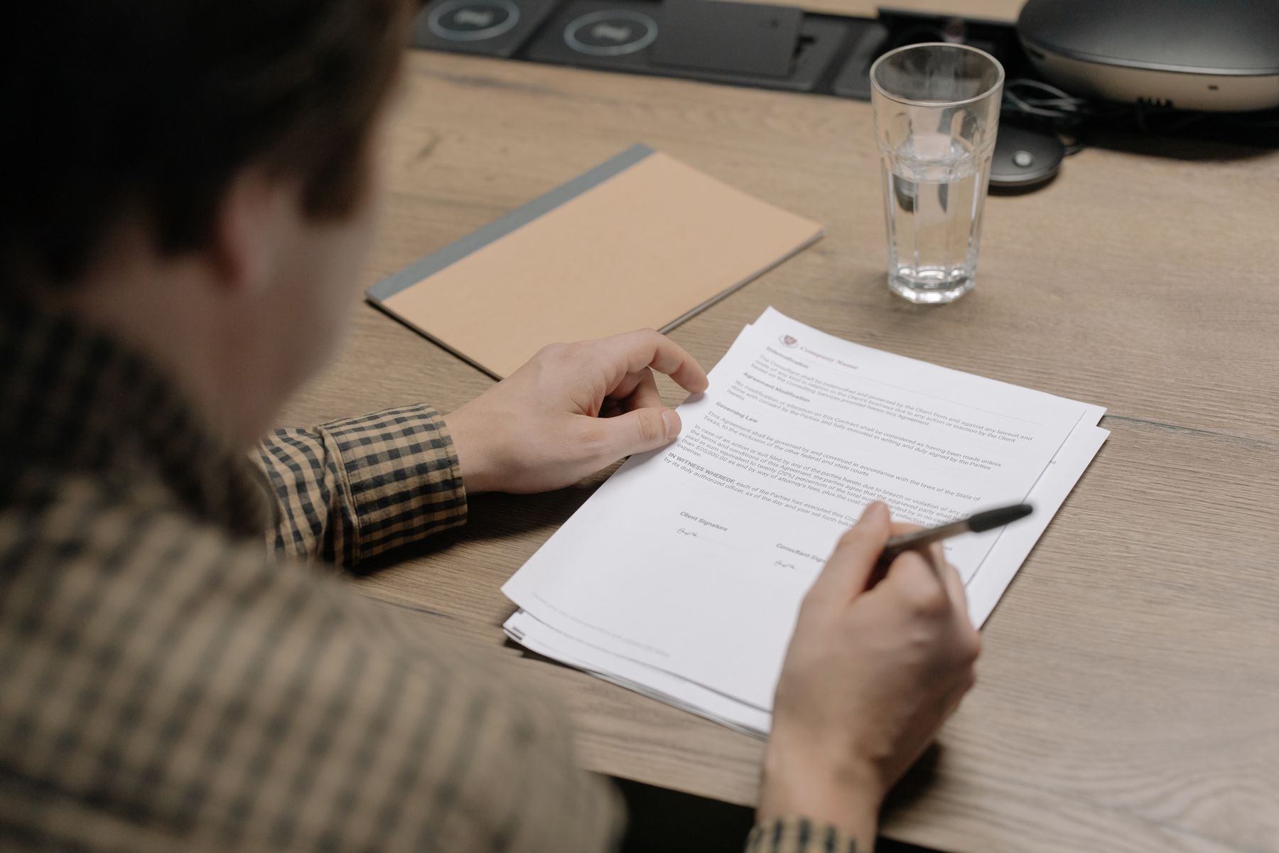 A businessperson reviewing and signing project documents