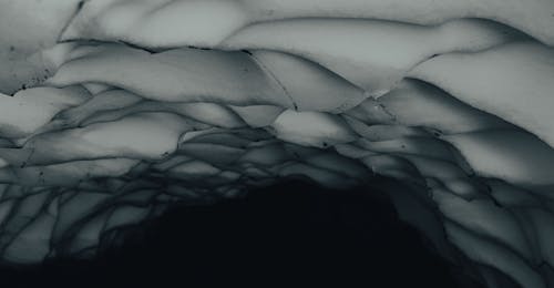 Close-up of an Icy Roof of a Dark Interior of an Ice Cave 