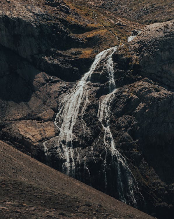 A Waterfall Flowing Down the Rocky Mountain