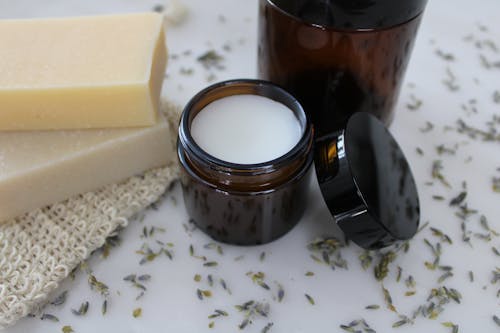 Brown Container Beside the Bars of Soup