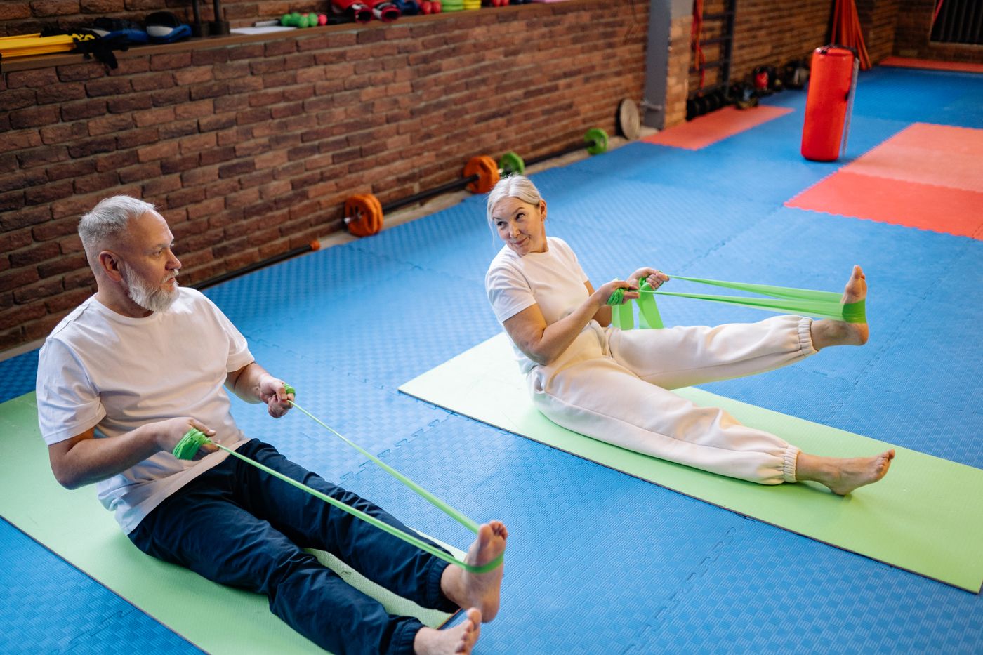 Active mature couple exercising with resistance bands