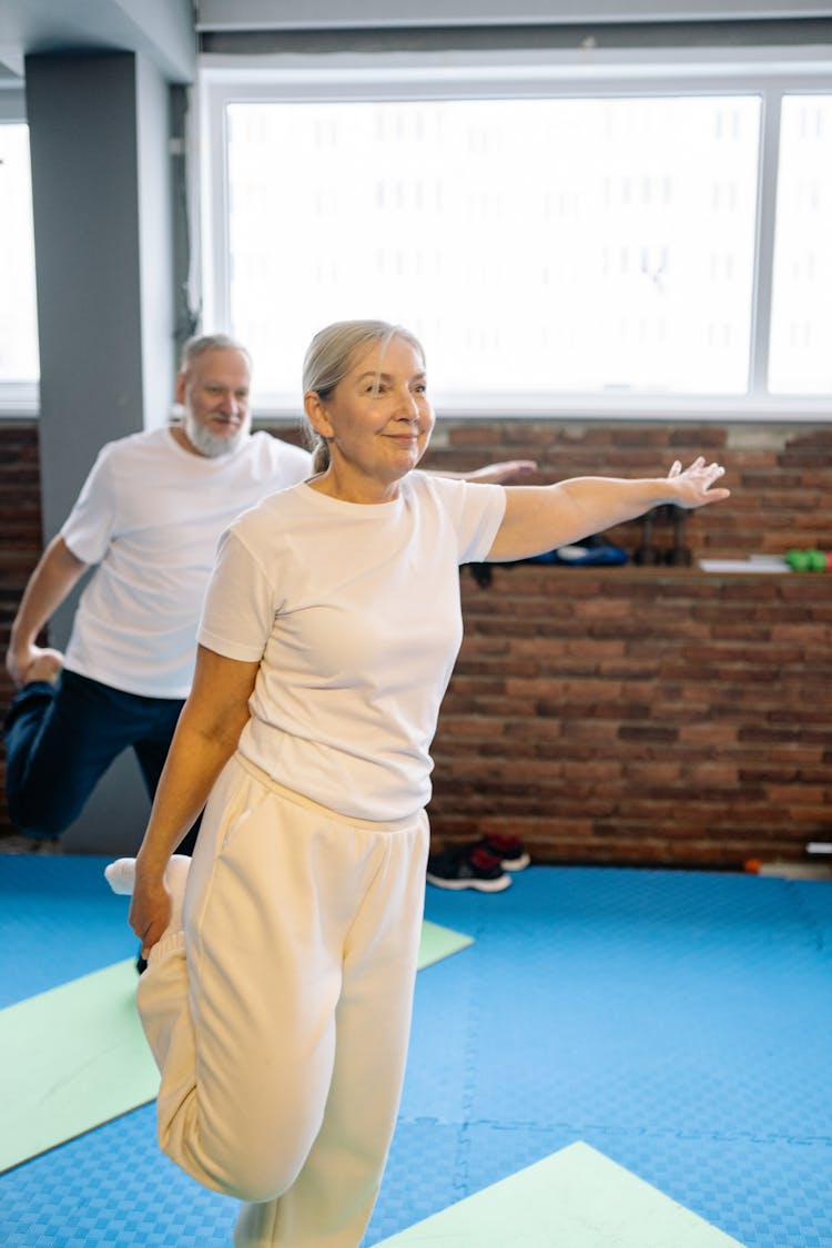 Elderly Couple Doing Leg Stretching