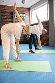 Senior adults stretch on mats in a fitness gym, promoting a healthy lifestyle.