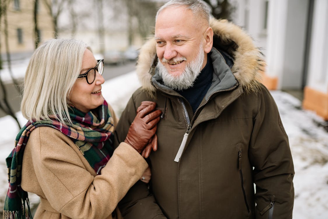 Free Man in Brown Coat Smiling Beside Woman in Brown Coat Stock Photo