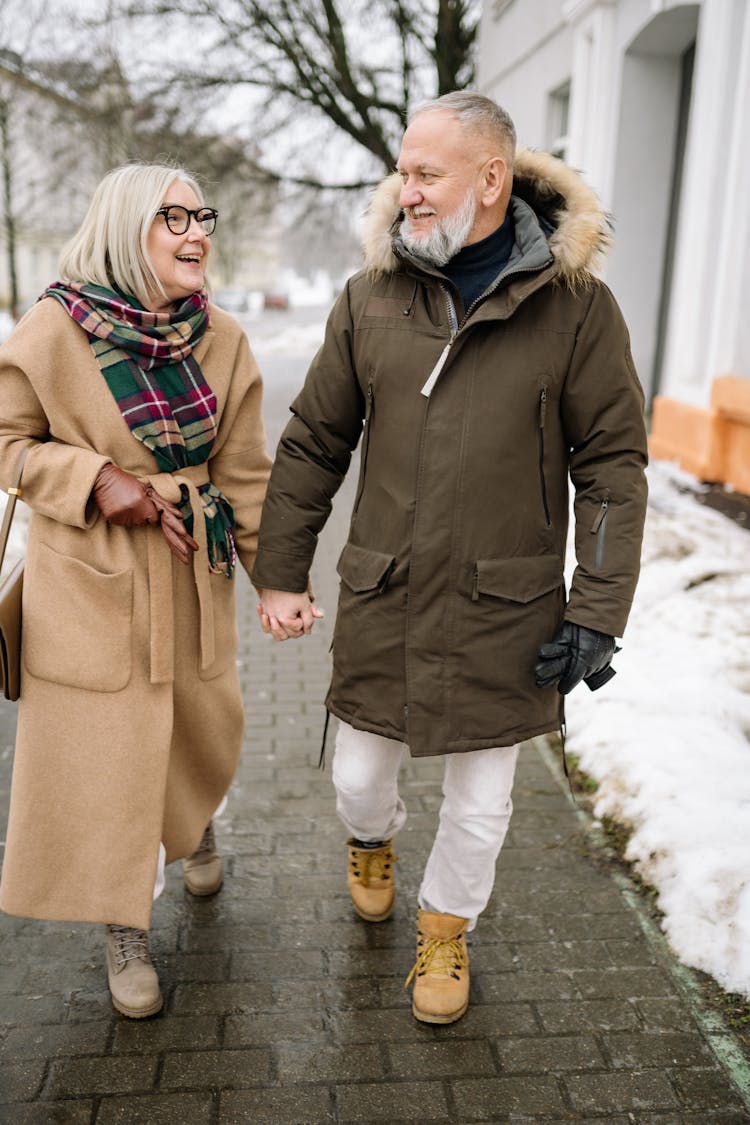 Elderly Couple Holding Hands While Walking