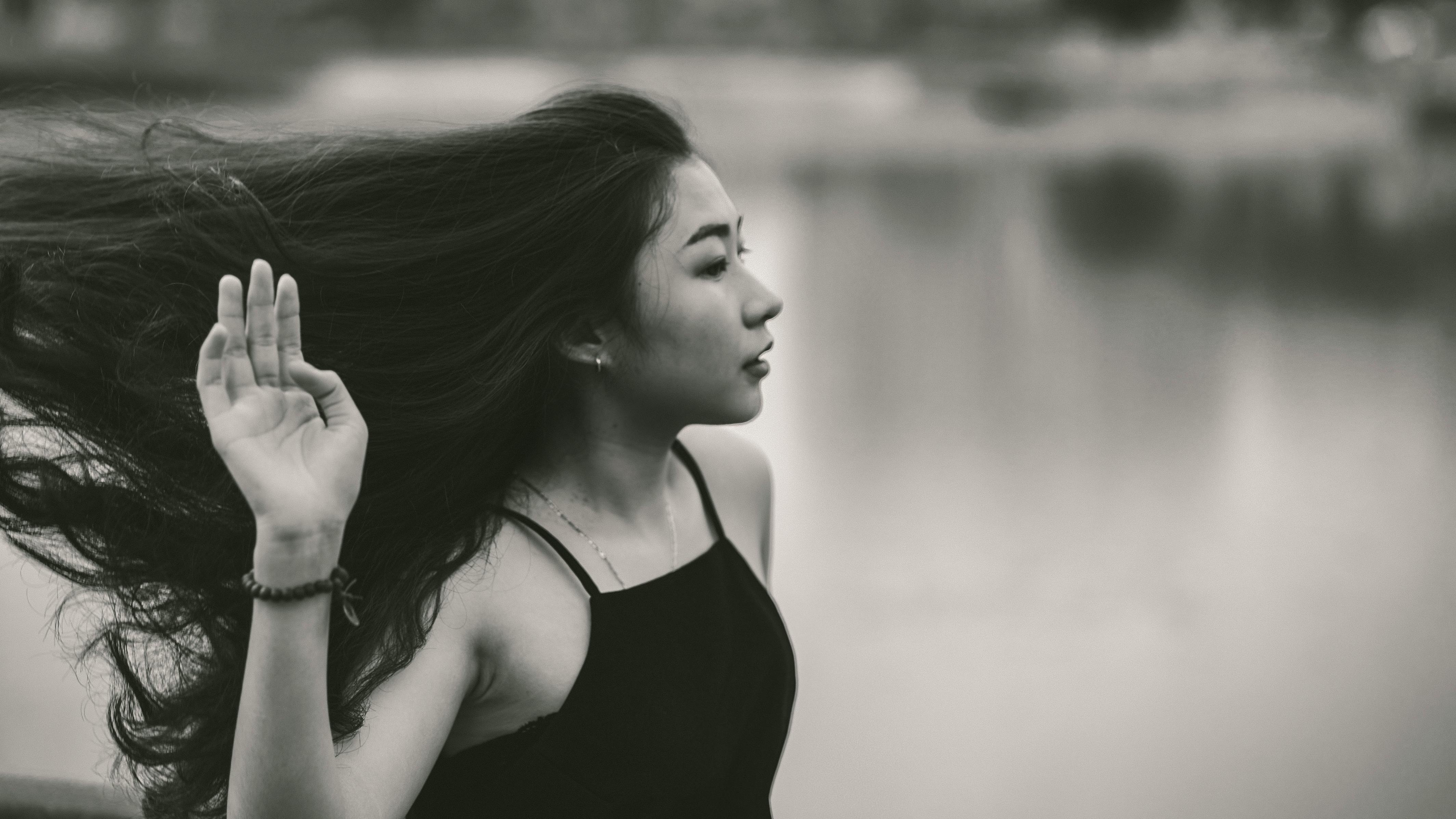 Grayscale Photo of Woman in Spaghetti Strap Top