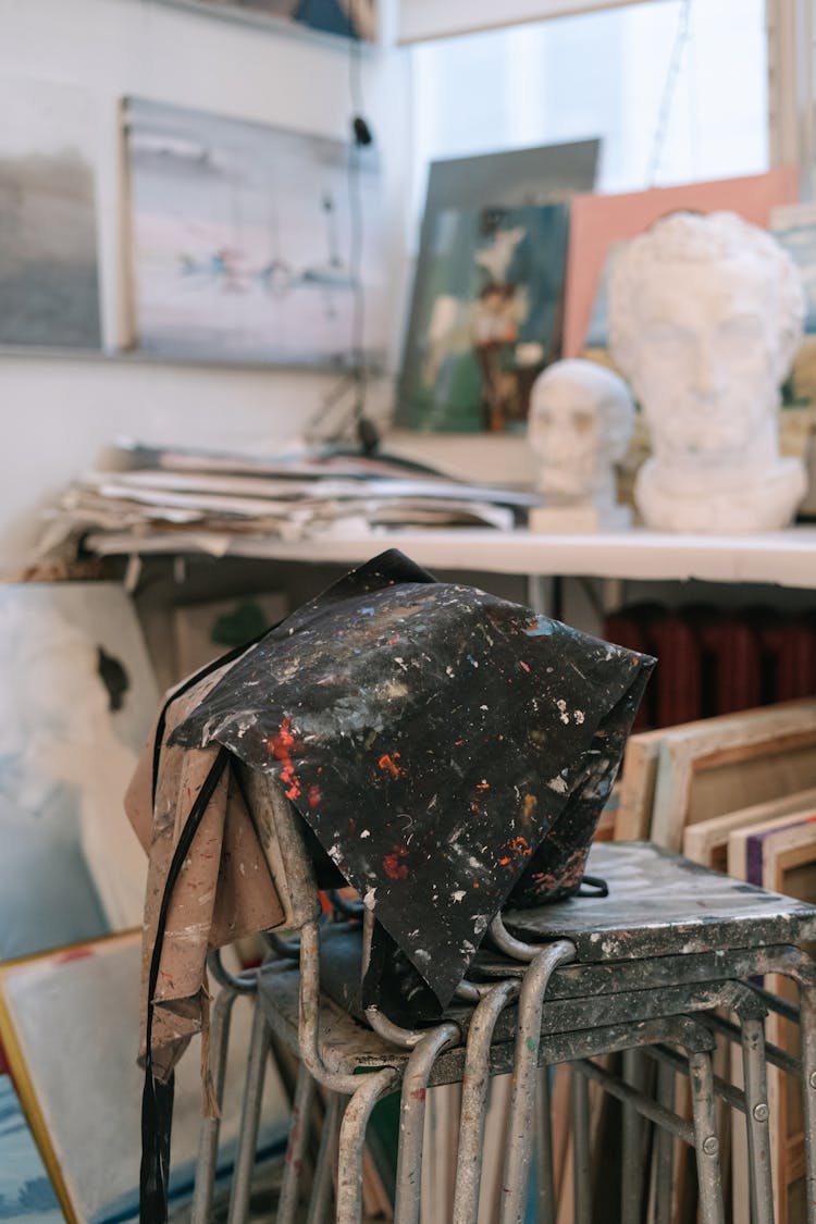 Dirty Aprons On Stacks Of Chairs