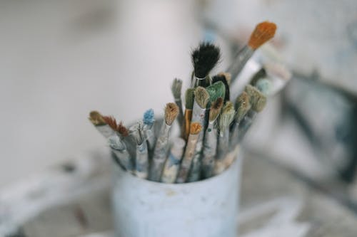 Paint Brushes in a White Container