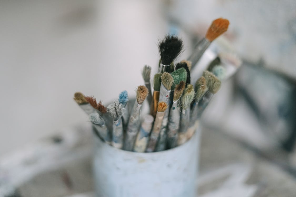 Paint Brushes in a White Container