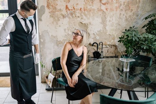 Women Ordering at a Glass Table in a Elegant Cafe with Textured Walls