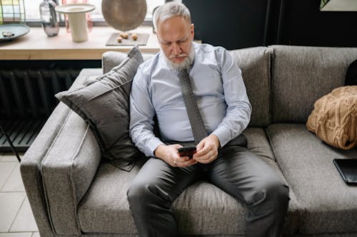 Man with Cellphone on Couch