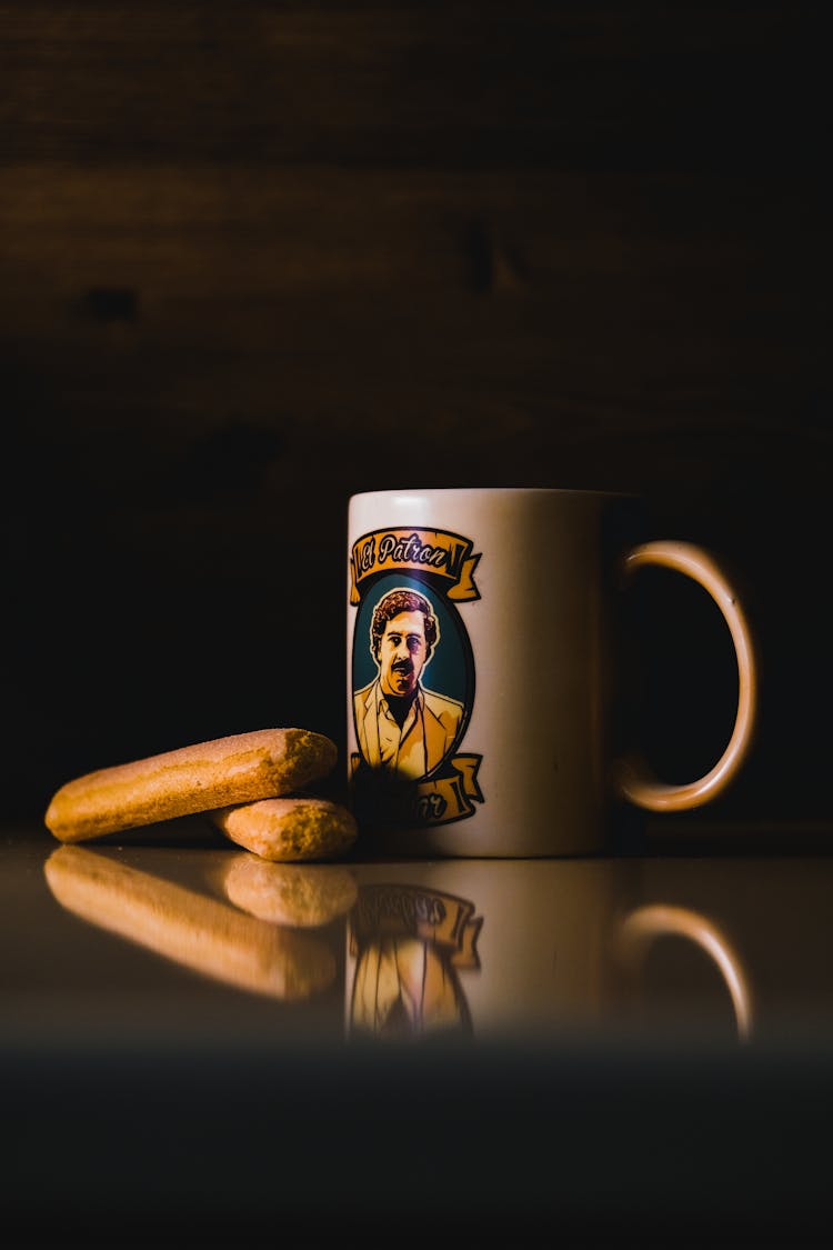 White And Black Ceramic Mug With Coffee Beans