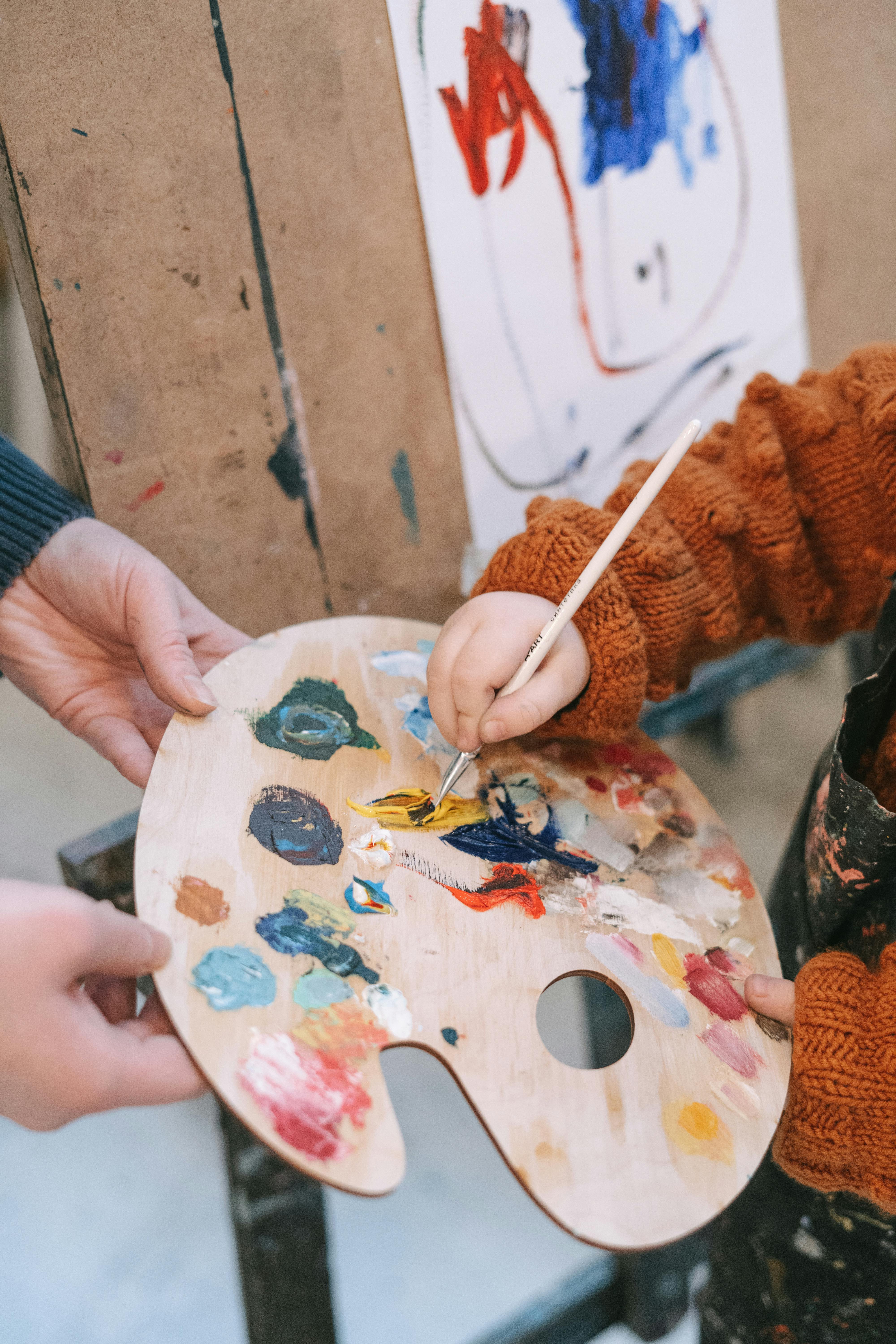 person holding white and blue floral hand fan