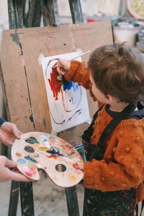 Child painting on an easel in art class