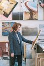 Woman in Blue Blazer Holding Brown Wooden Stick