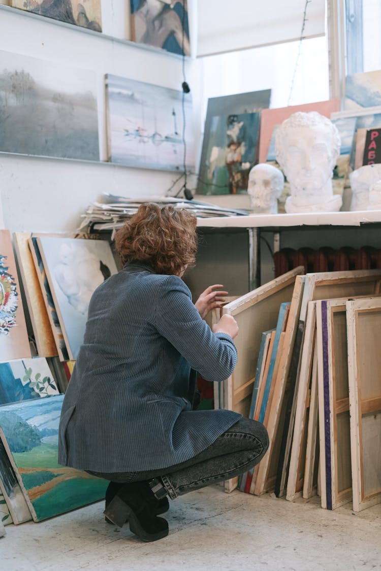 A Woman In Blazer Getting Canvas Under The Table