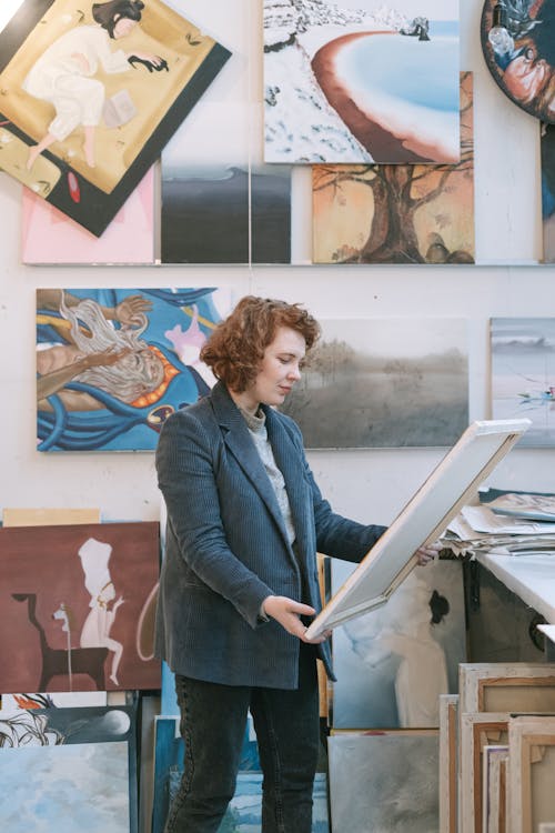 Free Woman in Blue Blazer Holding White Paper Stock Photo