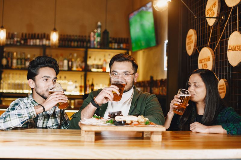 Friends sharing craft beer at Ironside Brewing Co. in Asheville, North Carolina