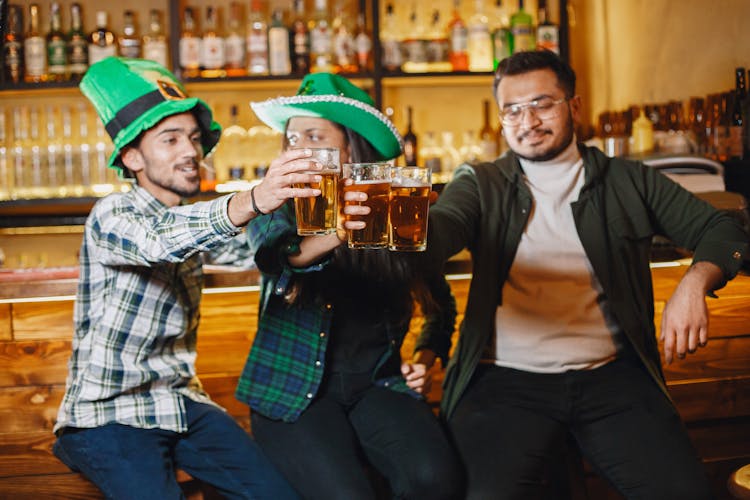 Happy Friends Drinking Beer In Pub