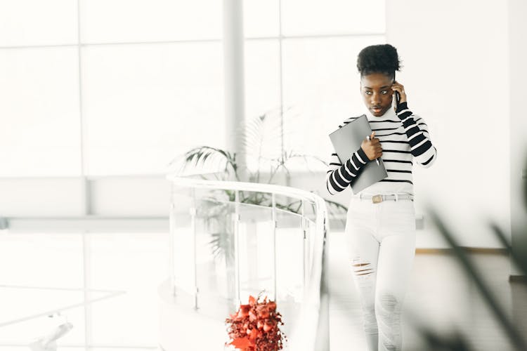 Young Businesswoman Talking On Cell In Office