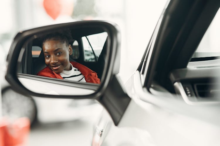 Woman Face In Car Mirror