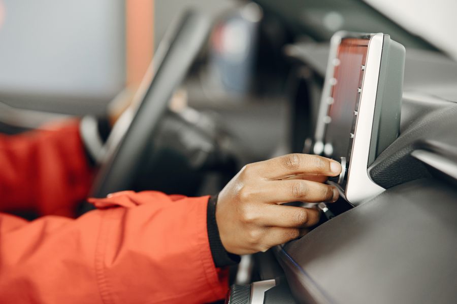 A hand adjusting a car's touchscreen head unit