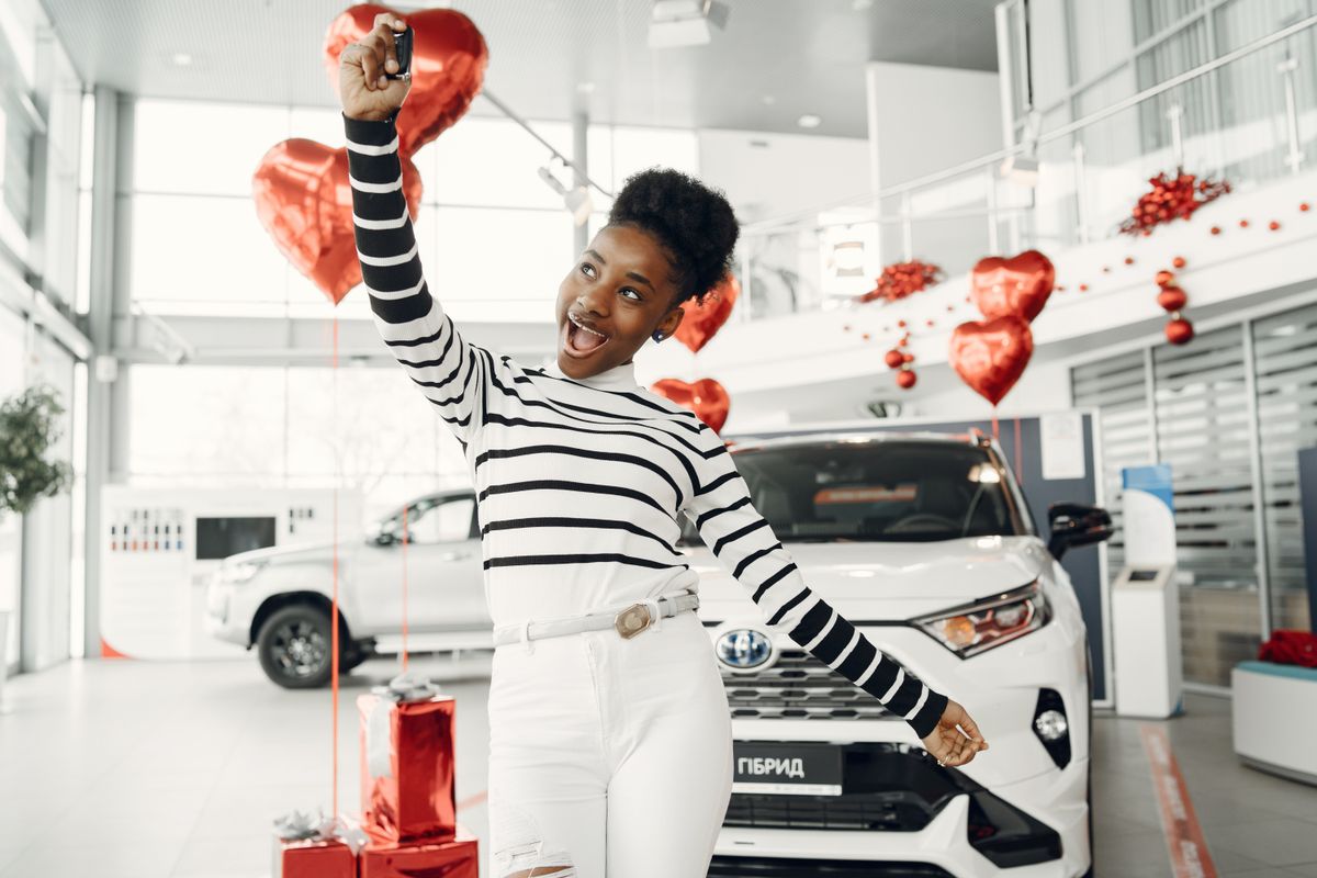 Happy learner driver holding car keys after passing