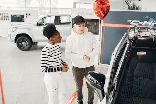 Man and Woman Looking at Cars