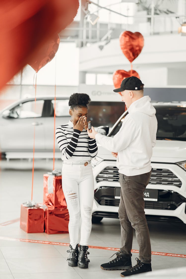 Man Giving A Car Key To A Woman 