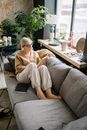 Woman Reading a Book Beside a Window