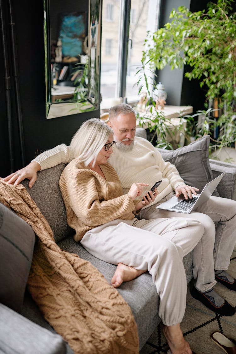 Elderly Couple Sitting On The Sofa