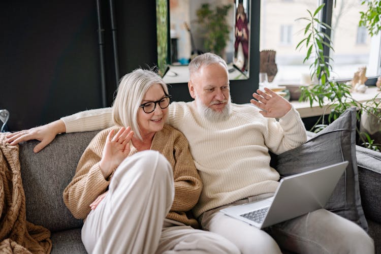 Elderly Couple Sitting On The Sofa