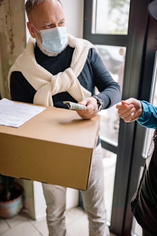 Free Man in Sweater Receiving a Delivery Stock Photo