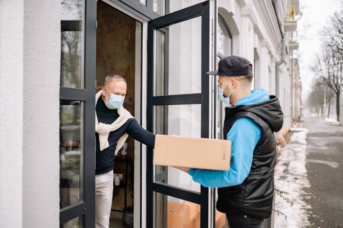 Free Man Delivering a Package to a Client Stock Photo