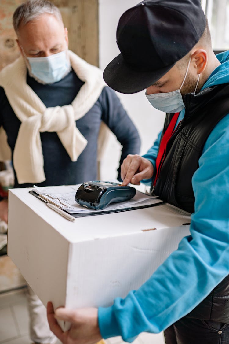 Delivery Man Using A Payment Terminal