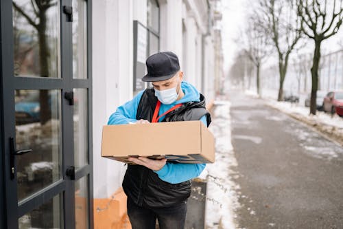 Free Man Carrying a Package on the Street Stock Photo