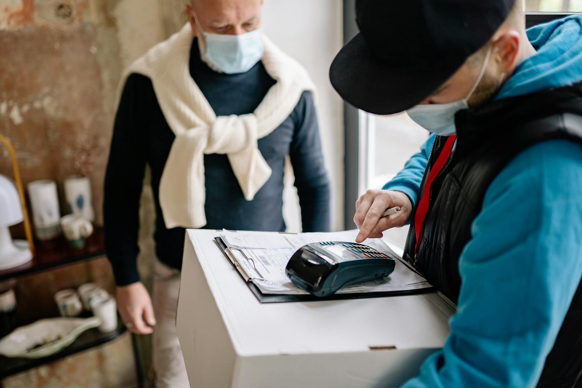 Delivery Man Using a Payment Terminal